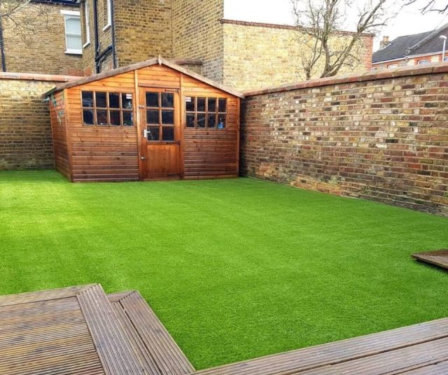 fake lawn installation in back garden in Essex, shed visible in photo