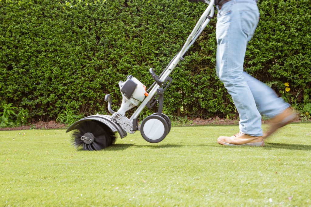 machine which fluffs up artificial grass